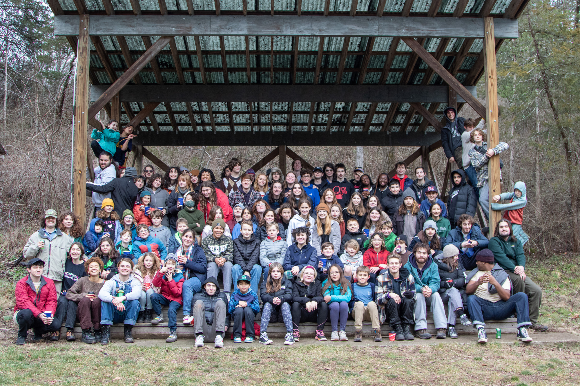 A group photo on the outdoor stage of everyone at the Winter Reunion